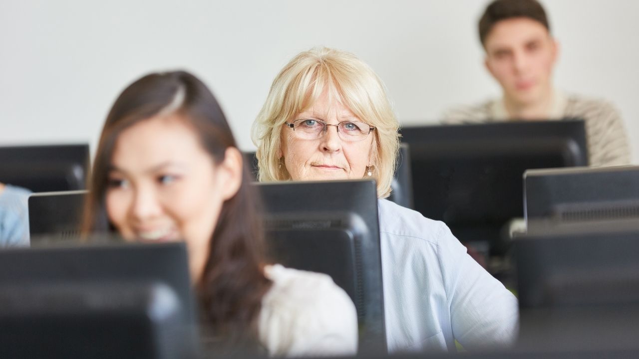 an elder student behind a computer